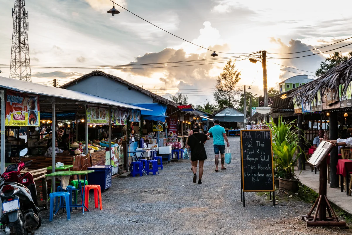 A dusk view down an aisle lined with stalls at Bang Niang Market