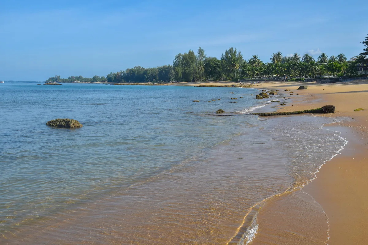 Shallow blue water and sand along Nang Thong Beach