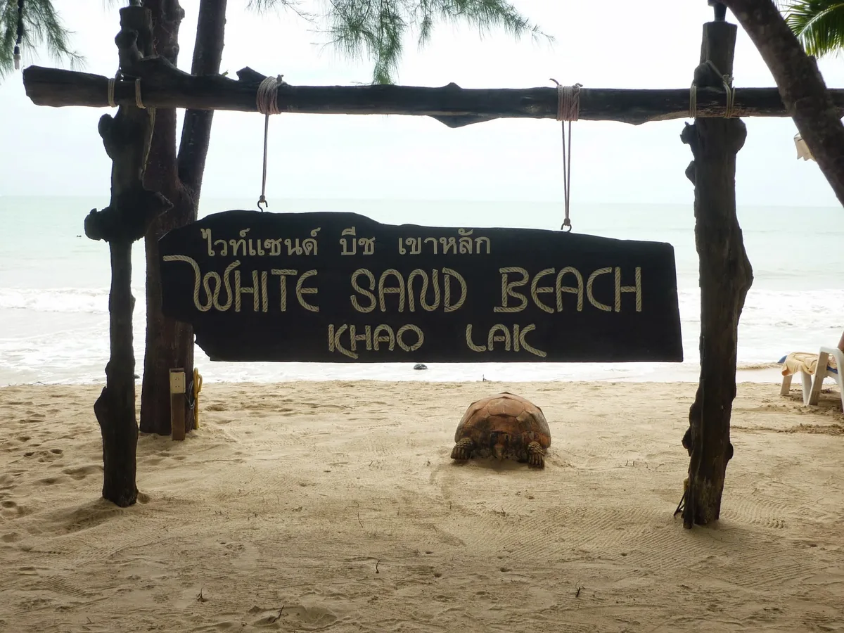 White Sand Beach Khao Lak sign hanging above the sand