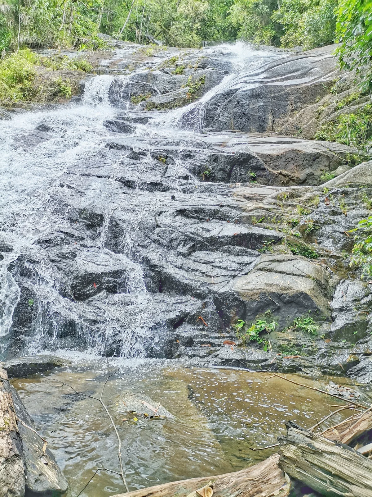 A broad rocky cascade at the fourth tier of Ton Chong Fa Waterfall