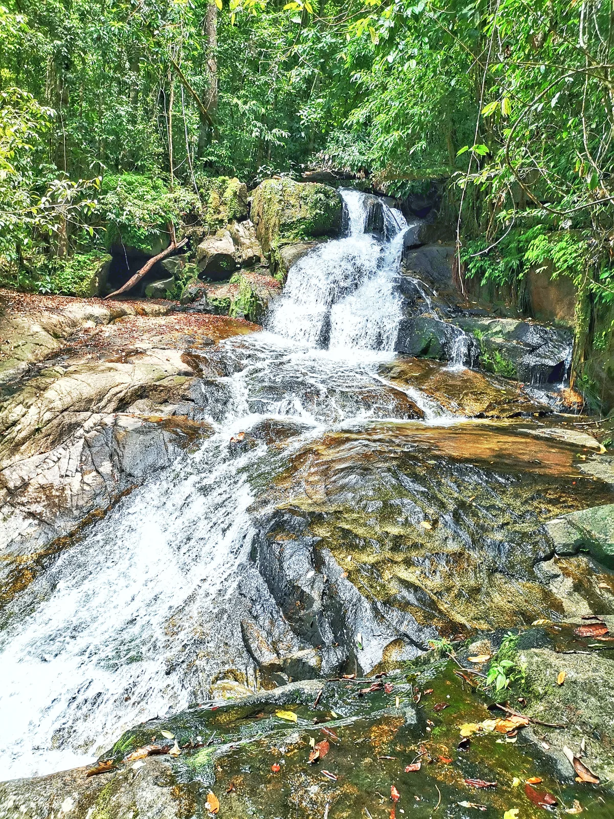 Water running over sloping rocks at Ton Chong Fa Waterfall's third tier