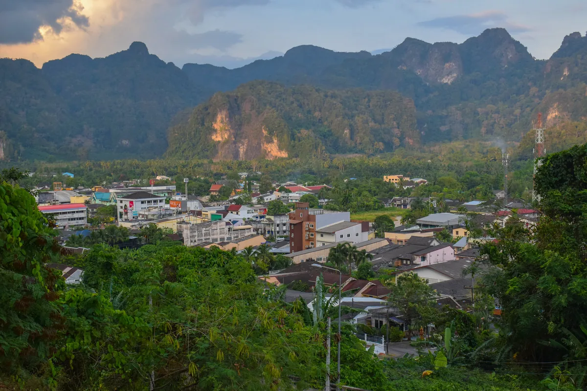Phang Nga town below a wall of forested limestone hills